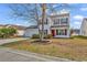 Charming two-story home with a well-maintained lawn and a vibrant red front door at 2629 Scarecrow Way, Myrtle Beach, SC 29579
