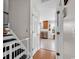 Hallway with hardwood floors leading to a kitchen and stairs with a safety gate at 2629 Scarecrow Way, Myrtle Beach, SC 29579