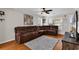 A well-lit living room features a brown sectional, hardwood floors, a ceiling fan, and a TV at 2629 Scarecrow Way, Myrtle Beach, SC 29579