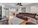 Spacious living room with a large brown sectional sofa, hardwood floors, and ample natural light at 2629 Scarecrow Way, Myrtle Beach, SC 29579
