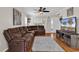 Comfortable living room with a plush sectional sofa, hardwood floors, ceiling fan, and entertainment center at 2629 Scarecrow Way, Myrtle Beach, SC 29579