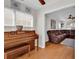 Sunroom featuring a vintage piano, wood floors, large windows, and view into living room at 2629 Scarecrow Way, Myrtle Beach, SC 29579