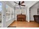 Bright sunroom with a vintage piano, multiple windows, and access to the living room at 2629 Scarecrow Way, Myrtle Beach, SC 29579