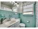 Quaint bathroom with turquoise tiling, vanity, and natural light at 325 52Nd Ave. N, North Myrtle Beach, SC 29582