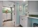 Bathroom with wood-look tile flooring, vanity, and peek at laundry closet at 325 52Nd Ave. N, North Myrtle Beach, SC 29582