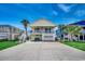Exterior of a two-story home with a large driveway and well-manicured lawn at 325 52Nd Ave. N, North Myrtle Beach, SC 29582