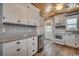 Well-lit kitchen with white cabinets, granite countertops and stainless steel appliances at 325 52Nd Ave. N, North Myrtle Beach, SC 29582