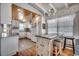 Bright kitchen features white cabinets, stainless steel appliances, and a wooden ceiling at 325 52Nd Ave. N, North Myrtle Beach, SC 29582
