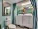 Laundry closet with washer, dryer, and upper shelving behind a curtain at 325 52Nd Ave. N, North Myrtle Beach, SC 29582