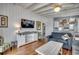 Living room with hardwood floors, ceiling fan, tv, and view of the kitchen at 325 52Nd Ave. N, North Myrtle Beach, SC 29582