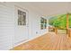 Covered deck with white siding and wood railings, overlooking trees at 3566 Steamer Trace Rd., Conway, SC 29527