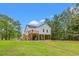 Exterior elevation of elevated coastal home on a grassy lot at 3566 Steamer Trace Rd., Conway, SC 29527