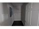 View of laundry room with grey walls, white door, and dark wood flooring at 3566 Steamer Trace Rd., Conway, SC 29527
