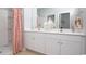 Well-lit bathroom featuring a double vanity, neutral colors and a walk-in shower at 362 Ladyfish Loop, Sunset Beach, NC 28468