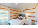 Bright bedroom with eye-catching striped walls, modern decor and comfortable furnishings at 362 Ladyfish Loop, Sunset Beach, NC 28468