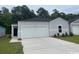 Charming single-Gathering home features a one car garage and manicured front yard at 362 Ladyfish Loop, Sunset Beach, NC 28468