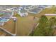 Aerial view showcasing a spacious backyard, pool, playset and surrounding neighborhood at 380 Harvest Ridge Way, Conway, SC 29527