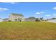 Spacious backyard with lush green grass, fencing, and a playset at 380 Harvest Ridge Way, Conway, SC 29527