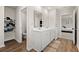 Well-lit bathroom featuring double vanity, wood flooring, and organized linen storage at 380 Harvest Ridge Way, Conway, SC 29527