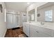 Well-lit bathroom with double sink vanity, large mirrors, and a walk-in shower at 380 Harvest Ridge Way, Conway, SC 29527