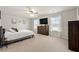 Serene primary bedroom with large windows, ceiling fan, and neutral tones for a relaxing ambiance at 380 Harvest Ridge Way, Conway, SC 29527