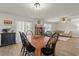 Open-concept dining area with wood table and chairs, seamlessly connecting to the living room at 380 Harvest Ridge Way, Conway, SC 29527