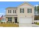 Charming two-story home with tan siding, dark shutters, and an attached two-car garage at 380 Harvest Ridge Way, Conway, SC 29527