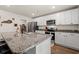 Spacious kitchen boasting white cabinets, granite counters, and stainless steel appliances at 380 Harvest Ridge Way, Conway, SC 29527