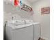 Laundry room featuring modern appliances and convenient overhead storage at 380 Harvest Ridge Way, Conway, SC 29527