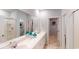 Bathroom featuring double sinks, white cabinetry, and a walk-in shower at 382 Ladyfish Loop, Sunset Beach, NC 28468