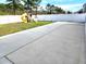 Concrete backyard with a playset and a tall fence that surrounds the yard at 5088 Wavering Place Loop, Myrtle Beach, SC 29579