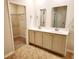 Bathroom featuring double sinks and a view into a walk-in closet with wire shelving at 5088 Wavering Place Loop, Myrtle Beach, SC 29579