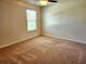 Neutral bedroom with plush carpeting, a ceiling fan, and natural light at 5088 Wavering Place Loop, Myrtle Beach, SC 29579