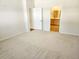 Empty bedroom with carpeted floor and open view into a bathroom and a walk-in closet at 5088 Wavering Place Loop, Myrtle Beach, SC 29579