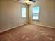 Bedroom with two windows, neutral walls, ceiling fan, and wall-to-wall carpeting at 5088 Wavering Place Loop, Myrtle Beach, SC 29579