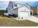 Side angle view of a well-kept two-story home with a two car garage at 5088 Wavering Place Loop, Myrtle Beach, SC 29579