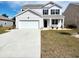Charming two-story home with a two car garage, well-manicured lawn, and black shutters at 5088 Wavering Place Loop, Myrtle Beach, SC 29579