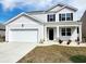 Charming two-story home with a two car garage, well-manicured lawn, and black shutters at 5088 Wavering Place Loop, Myrtle Beach, SC 29579
