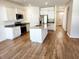 Modern kitchen features white cabinets, stainless appliances, granite countertops, and a kitchen island at 5088 Wavering Place Loop, Myrtle Beach, SC 29579