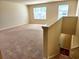 Spacious living room with stairs, large windows and plush carpeting at 5088 Wavering Place Loop, Myrtle Beach, SC 29579