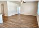 Empty living room with light-colored laminate flooring, a ceiling fan and lots of natural light at 5088 Wavering Place Loop, Myrtle Beach, SC 29579