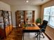 Home office featuring hardwood floors, stylish bookshelves, and a large window at 5088 Wavering Place Loop, Myrtle Beach, SC 29579