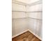 Walk-in pantry with white wire shelving, offering ample storage space and hardwood floors at 5088 Wavering Place Loop, Myrtle Beach, SC 29579