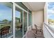 Relaxing balcony with chairs, offering views of the beach and palm trees at 5300 N Ocean Blvd. # 217, Myrtle Beach, SC 29577