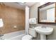 Well-lit bathroom with tiled shower-tub, toilet and single sink pedestal with framed mirror at 5300 N Ocean Blvd. # 217, Myrtle Beach, SC 29577