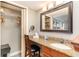 Bathroom vanity featuring granite counters, decorative mirror and convenient seating area at 5300 N Ocean Blvd. # 217, Myrtle Beach, SC 29577