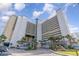 Low angle exterior shot of a beachfront resort featuring palm trees and direct access to the sandy shores at 5300 N Ocean Blvd. # 217, Myrtle Beach, SC 29577