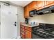 Compact kitchenette features a microwave, stovetop, sink, and essential amenities at 5300 N Ocean Blvd. # 217, Myrtle Beach, SC 29577