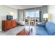Inviting living room with a comfortable sofa and sliding glass doors revealing a stunning ocean view at 5300 N Ocean Blvd. # 217, Myrtle Beach, SC 29577