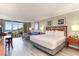 Bright open-concept bedroom featuring balcony access, a cozy sofa, and a well-appointed bedroom area at 5300 N Ocean Blvd. # 217, Myrtle Beach, SC 29577